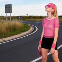 Mandotos International PESENAR 80s neon pink mesh costume accessory set with leg warmers, sunglasses, and earrings.