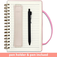Pink girls' A5 travel leather spiral notebook by MANDOTOS INTERNATIONAL with pen holder and matching pen for writing.