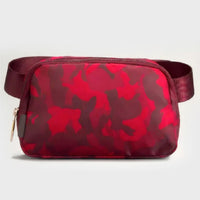 Mandotos International lightweight women's waist bag for running and travel, shown in black with adjustable strap and secure zipper.