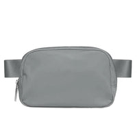 Mandotos International lightweight women’s waist bag for running and travel, shown in black with adjustable strap and zipper pockets.
