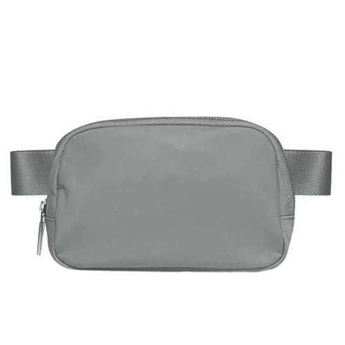 Mandotos International lightweight women’s waist bag for running and travel, shown in black with adjustable strap and zipper pockets.