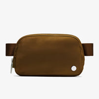 Mandotos International lightweight women's waist bag for running and travel, shown in black with adjustable strap and compact design.