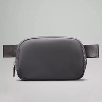 Mandotos International premium lightweight women’s waist bag for running and travel, shown in black with adjustable strap.