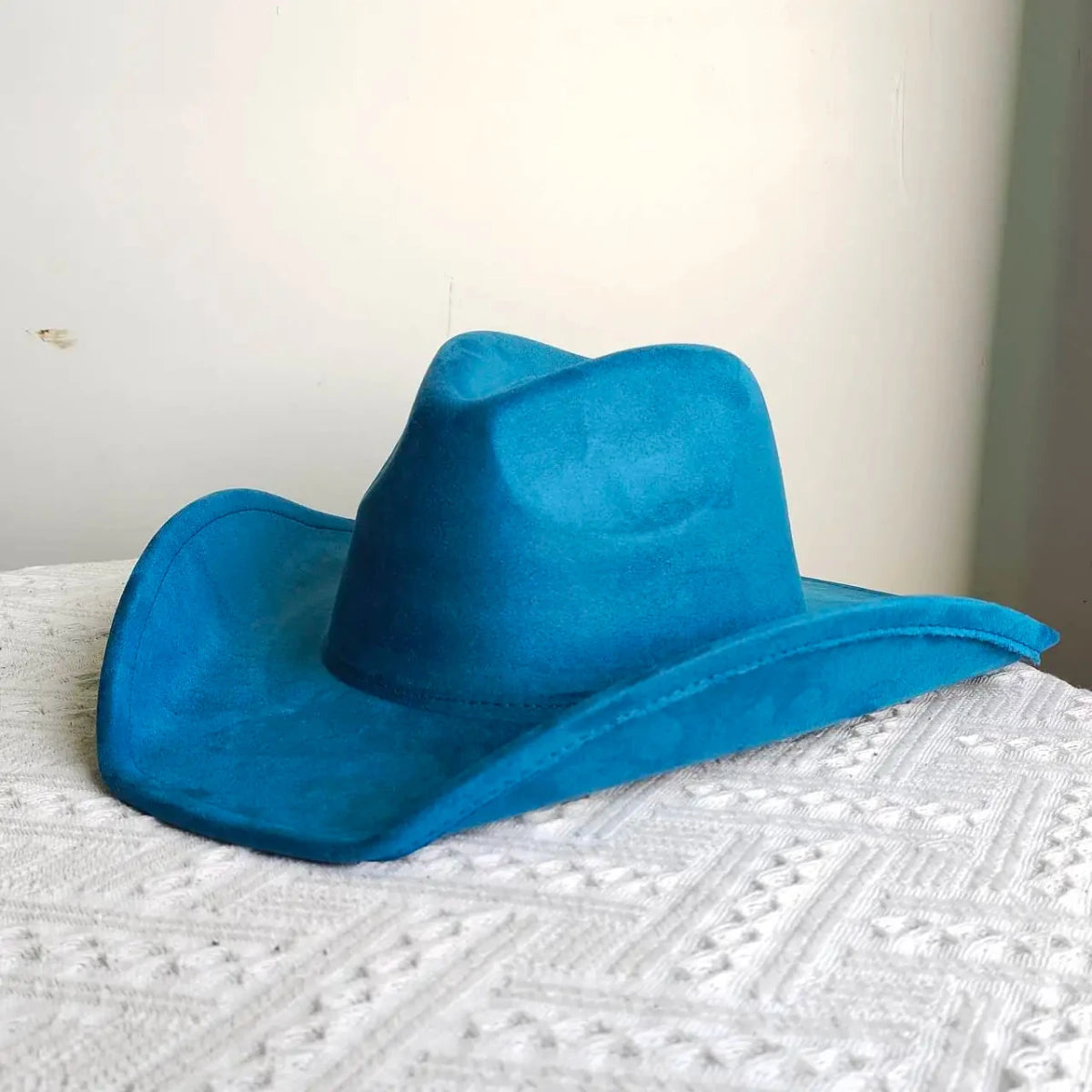 Premium suede cowboy hat by MANDOTOS INTERNATIONAL, stylish unisex accessory for outdoor festivities, with a wide brim and classic design.