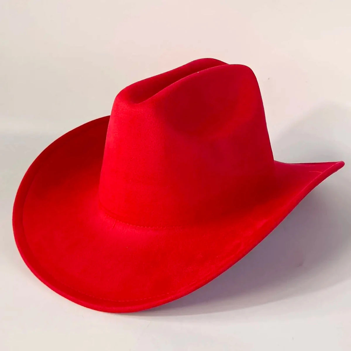 Premium suede cowboy hat by MANDOTOS INTERNATIONAL, stylish for men and women, ideal for outdoor festivities, with a wide brim and decorative band.
