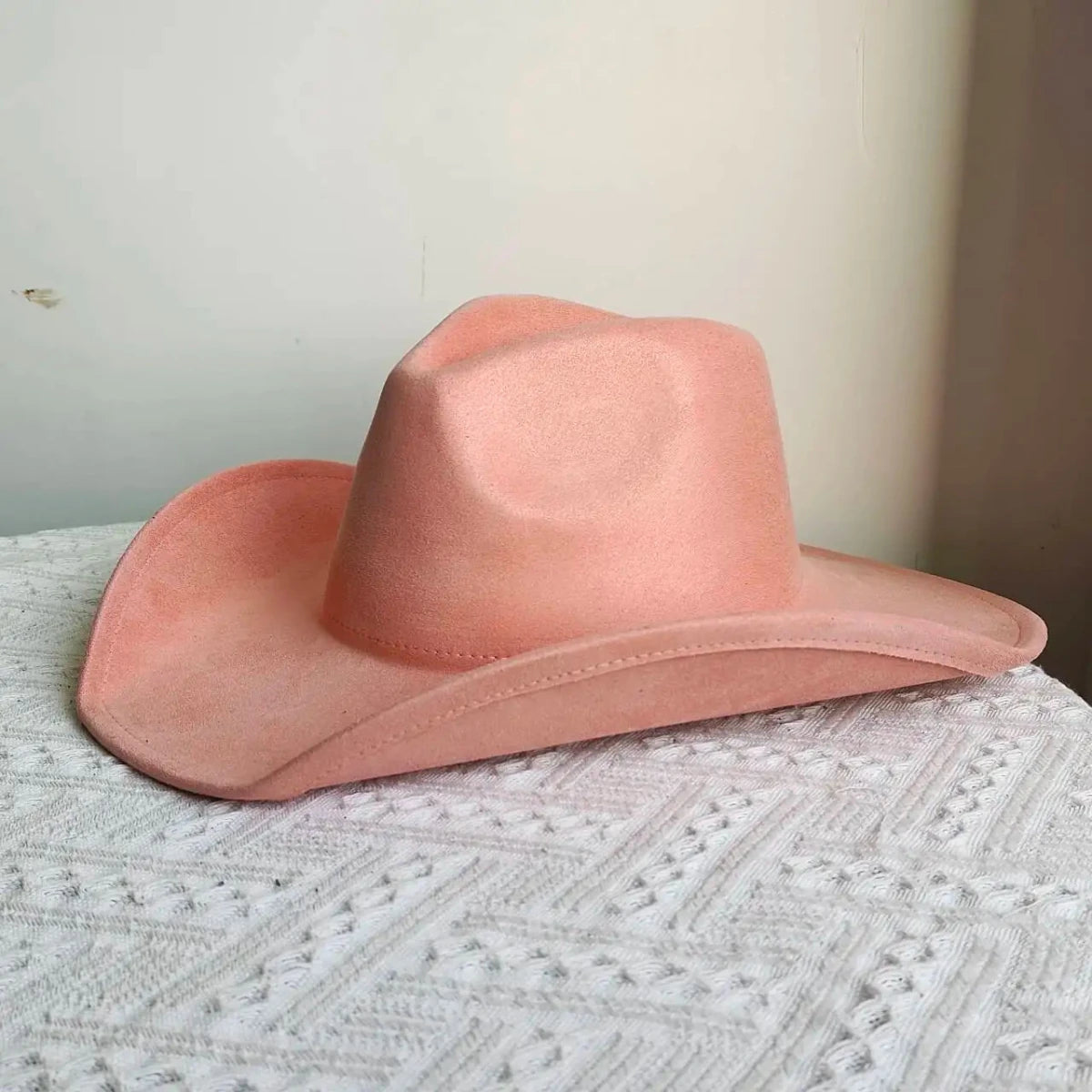 Premium suede cowboy hat by MANDOTOS INTERNATIONAL with wide brim, stylish design, perfect for outdoor festivities for men and women.