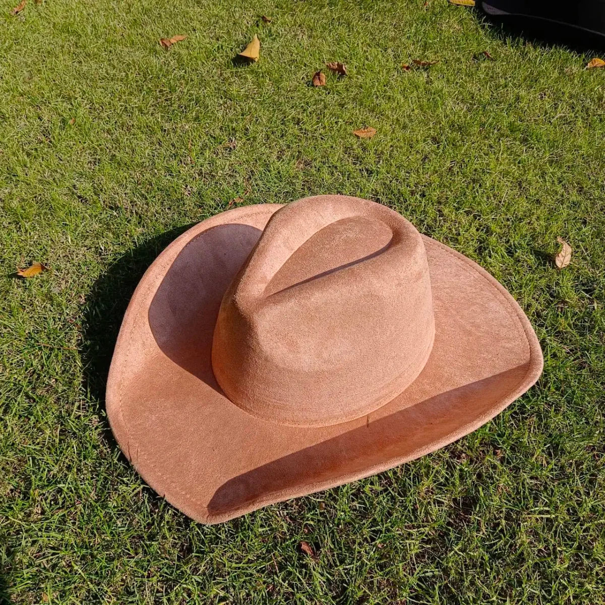 Premium suede cowboy hat by Mandotos International, stylish unisex accessory with a wide brim, ideal for outdoor festivities.