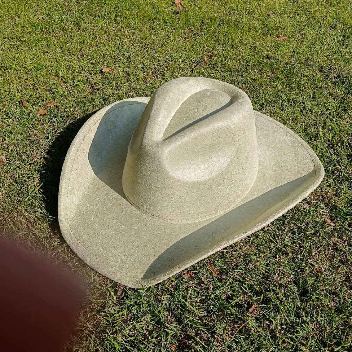 Premium suede cowboy hat by MANDOTOS INTERNATIONAL, stylish accessory for men and women, perfect for outdoor festivities.