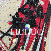 Red synchronized swimming team performance swimsuit by MANDOTOS INTERNATIONAL, featuring sleek design and flexible fit for competitive swimming.
