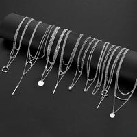 Mandotos International retro geometric pendant necklace, stylish jewelry piece for trendy travel dates, featuring modern design elements.