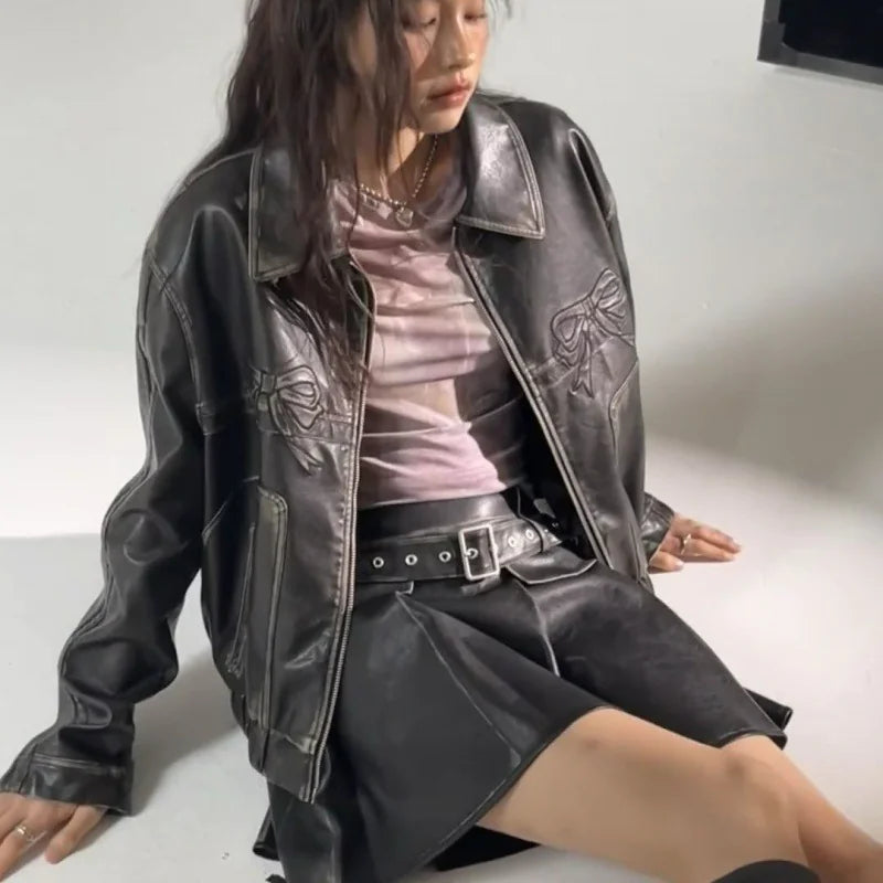 Mandotos International Rider's Bow leather jacket featuring a sleek black design with detailed stitching and classic collar.