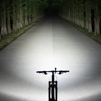 Mandotos International super bright LED bicycle front light mounted on a bike for night riding visibility and safety