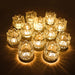Set of 12 Tulip Glow tea light glass holders by Mandotos International, decorative votive candle holders with tulip-shaped design.