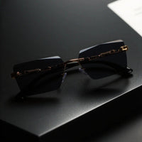 Unisex luxury frameless black and gold sunglasses with leopard print, rectangular lenses, UV400 protection, elegant design.