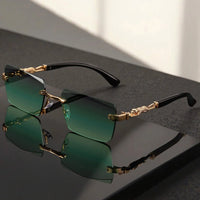 Unisex luxury frameless black and gold sunglasses with leopard print, thin rectangular lenses, UV400 protection, elegant design.