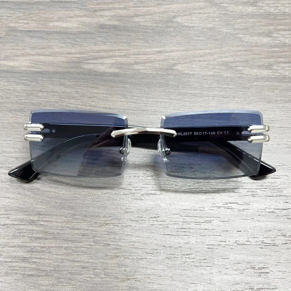 Vintage rimless sunglasses with stylish PC frames by Mandotos International, featuring sleek, modern design and clear lenses.