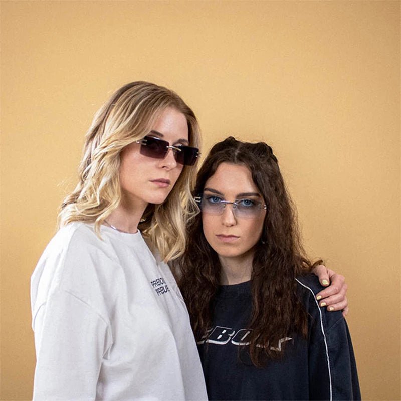 Vintage rimless sunglasses with stylish PC frames by MANDOTOS INTERNATIONAL, showcasing sleek, modern eyewear design.
