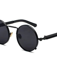 Vintage steampunk circular shades by MANDOTOS INTERNATIONAL featuring metal frames and tinted lenses for a retro look.