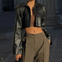 Black Vogue PU cropped jacket by MANDOTOS INTERNATIONAL, featuring a stylish, fitted design with a collar and zipper front.