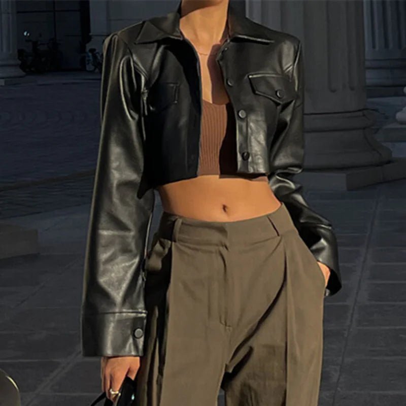 Black Vogue PU cropped jacket by MANDOTOS INTERNATIONAL, featuring a stylish, fitted design with a collar and zipper front.
