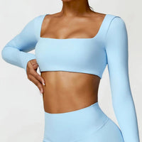 Women's long sleeve fitness T-shirt by MANDOTOS INTERNATIONAL, gym push-up top, made for comfortable workouts and active wear.