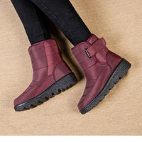 Women's waterproof winter snow boots by MANDOTOS INTERNATIONAL, non-slip ankle boots with warm platform soles, ideal for cold weather.