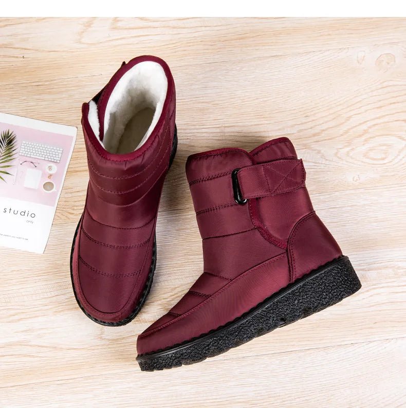 Women's waterproof winter snow boots by MANDOTOS INTERNATIONAL with non-slip soles, warm lining, and platform heel, ankle height.