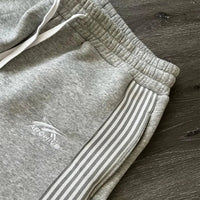 Y2k embroidered black and gray tactical jogger pants with camo accents, drawstring waist, suitable for men and women, by MANDOTOS INTERNATIONAL.