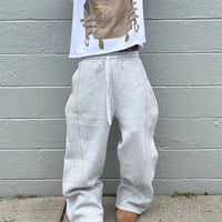 Black and gray Y2K embroidered tactical jogger pants with camo accents, drawstring waist, suitable for men and women.