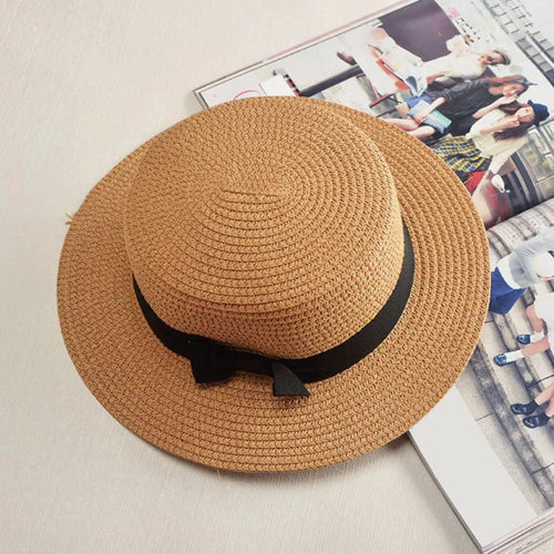 Mandotos Island Breeze Boater hat in natural straw with a wide brim and black ribbon for sun protection and stylish summer wear.