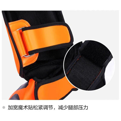 Mandotos kickboxing shin guards for Muay Thai, black leg protectors with padding for training and competition.