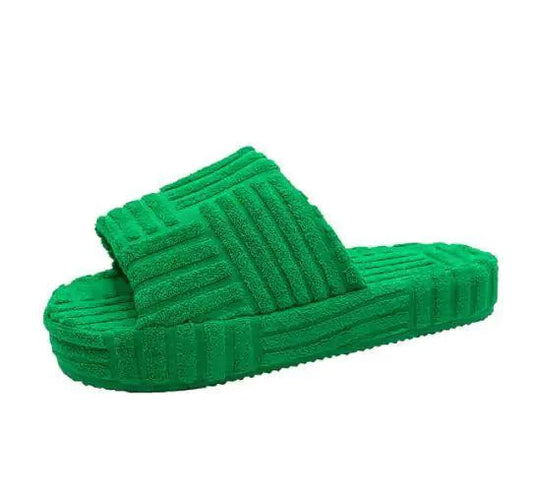 Soft pink plush slip-on slippers for women from MANDOTOS, featuring cozy, cushioned interior and non-slip soles.