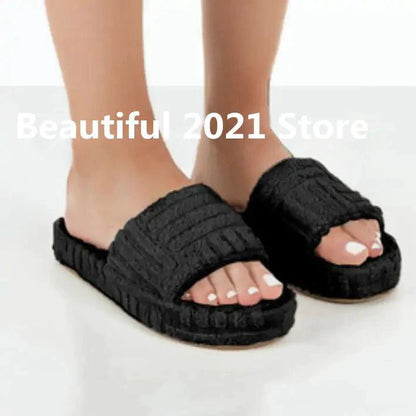 Comfortable ladies' plush slip-on slippers by MANDOTOS with soft, cozy fabric for indoor wear.
