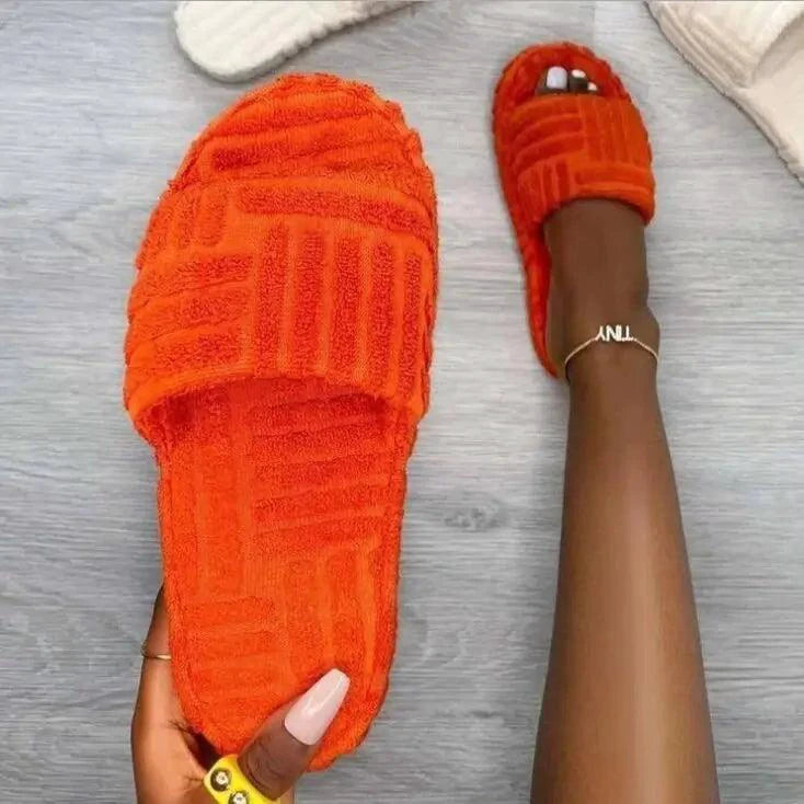 Comfortable ladies' plush slip-on slippers by MANDOTOS with soft, cozy fabric and slip-on design for indoor wear.