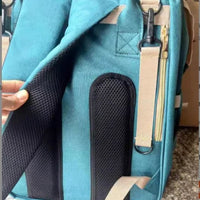 Large capacity mommy bag by MANDOTOS with multiple compartments, shown with baby essentials and organized interior pockets.