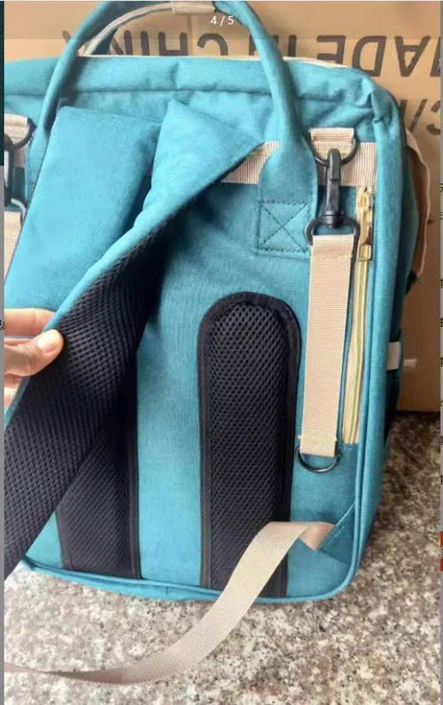 Large capacity mommy bag by MANDOTOS with multiple compartments, shown with baby essentials and organized interior pockets.