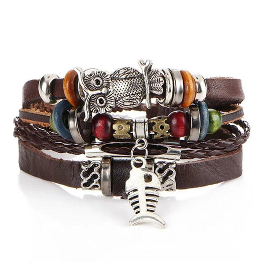 Layered leather charm bracelet by MANDOTOS featuring multiple leather strands and metal charms on a neutral background.