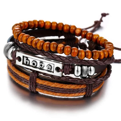 Layered leather charm bracelet by MANDOTOS with metal and bead accents, styled with multiple leather straps.