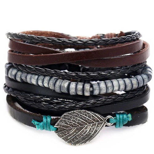 Layered leather charm bracelet by MANDOTOS featuring multiple leather strands and decorative metal charms.