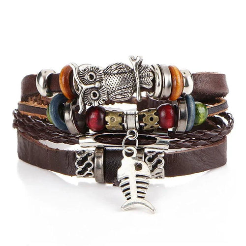 Layered leather charm bracelet by MANDOTOS with metal and bead accents, featuring multiple leather straps and decorative charms.