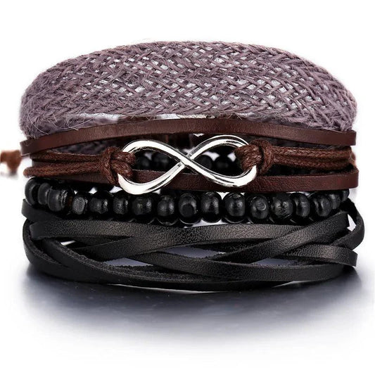 Layered leather charm bracelet by MANDOTOS featuring multiple leather bands and decorative metal charms.