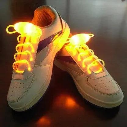 Mandotos LED light-up shoelaces glowing in the dark, flexible and vibrant for athletic shoes and casual wear.