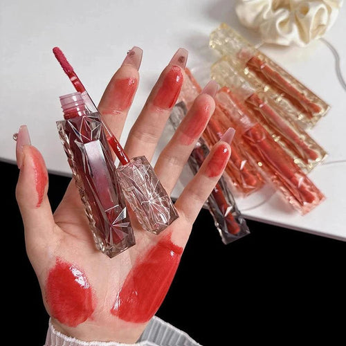 Mandotos long-lasting lip gloss with moisturizing, waterproof formula and mirror finish, shown on lips.