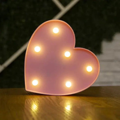 Mandotos luminous letter lights spelling out a word, illuminated in a cozy indoor setting, perfect for bedroom or decor use.