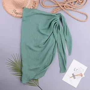 Mandotos LuxeWave chiffon beach wrap draped over a woman, showcasing its lightweight, chic, and versatile cover-up design for beach or pool.