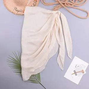 Mandotos LuxeWave chiffon beach wrap draped over a model, showcasing its lightweight, versatile design for effortless chic beach style.