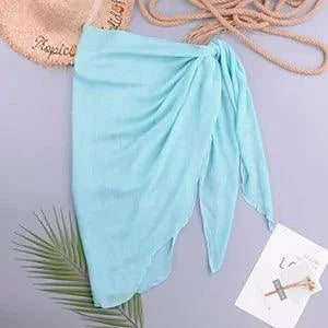 Mandotos LuxeWave chiffon beach wrap draped over a model, showcasing its lightweight, sheer fabric and versatile, chic style for beachwear.