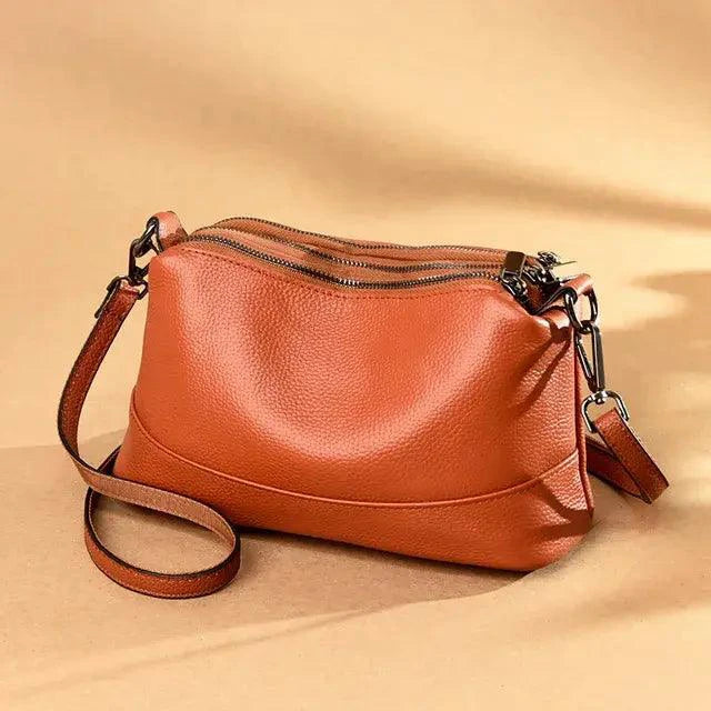 Mandotos luxury genuine leather handbag with sleek design, featuring sturdy handles and elegant stitching.