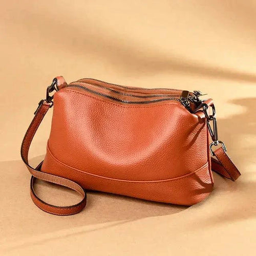 Mandotos luxury genuine leather handbag with sleek design, featuring sturdy handles and elegant stitching.