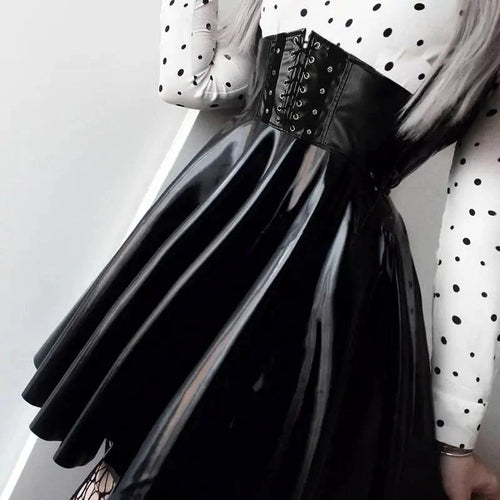 Mandotos black leather lace-up skirt with front lacing and fitted design, styled on a model for a trendy fashion look.